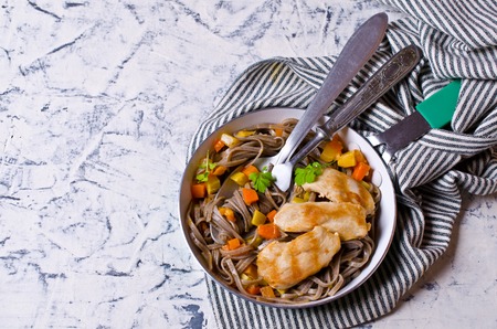 Dark pasta with steamed vegetables and grilled chicken. Selective focus.の写真素材