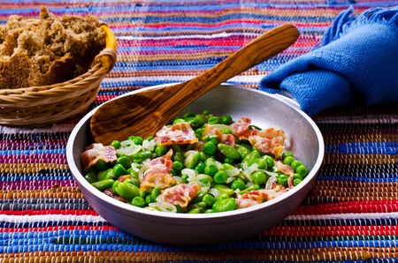 Fried bacon with broad beans and peas. Selective focus.の写真素材