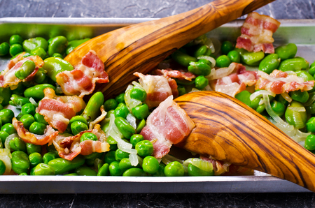 Fried bacon with broad beans and peas. Selective focus.の写真素材