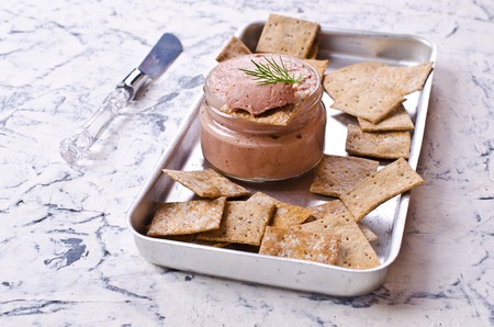 Liver pate with crisps on a light background. Selective focus.の写真素材