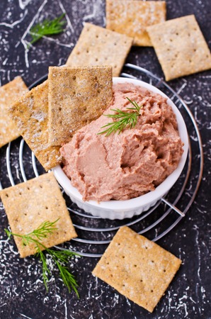 Liver pate with crisps on a dark background. Selective focus.の写真素材