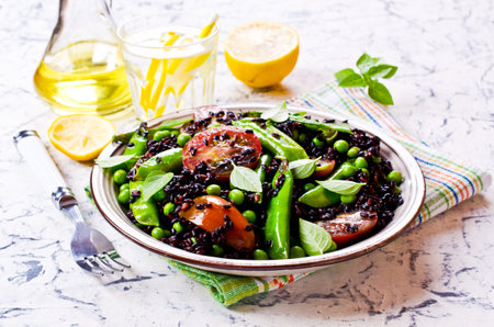Salad with black rice, peas and tomatoes. Selective focus.の写真素材