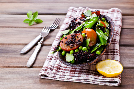 Salad with black rice, peas and tomatoes. Selective focus.の写真素材