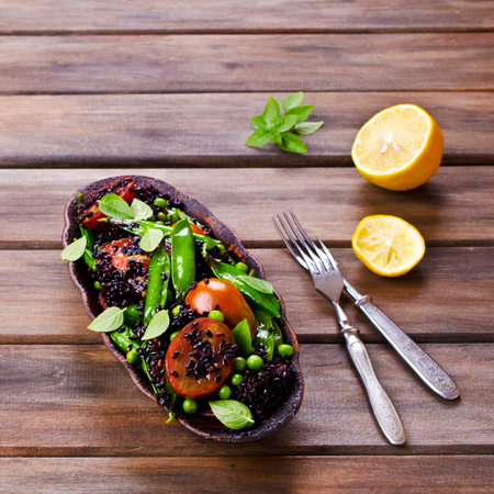 Salad with black rice, peas and tomatoes. Selective focus.の写真素材