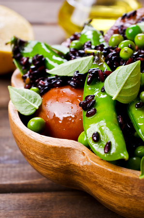 Salad with black rice, peas and tomatoes. Selective focus.の写真素材