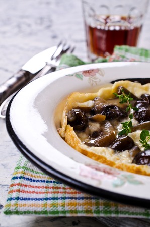 Scrambled eggs with mushrooms on a light background. Selective focus.の写真素材