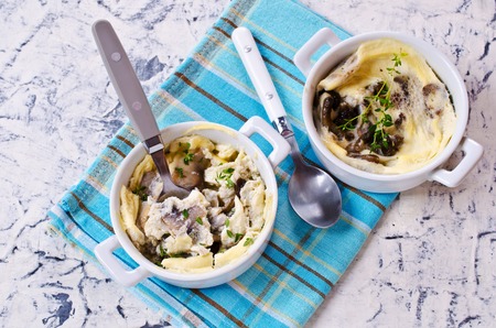 Scrambled eggs with mushrooms on a light background. Selective focus.の写真素材