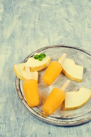 Homemade ice lolly of melon on a light background. Selective focus.の写真素材