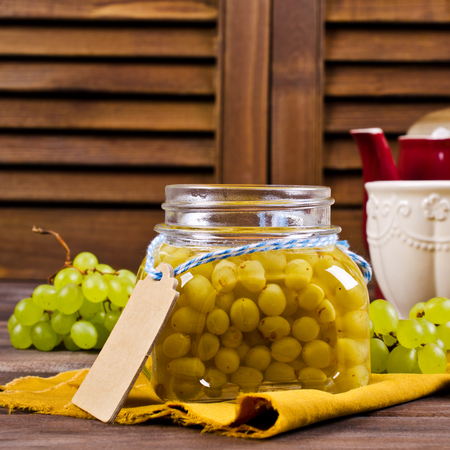 Jam of green grapes on a wooden background. Selective focus.の写真素材