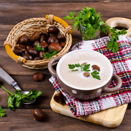 Cream soup of pureed chestnuts on a wooden background. Selective focus.の写真素材