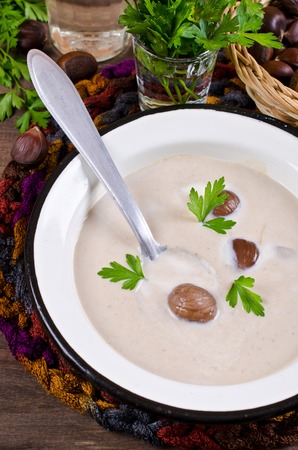 Cream soup of pureed chestnuts on a wooden background. Selective focus.の写真素材