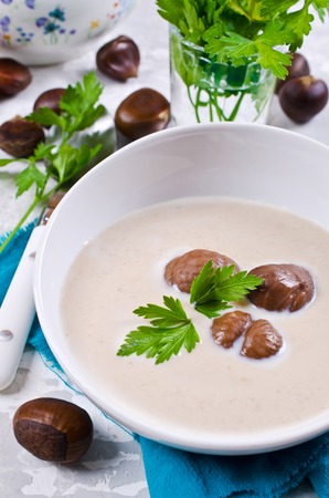 Cream soup of pureed chestnuts on a concrete background. Selective focus.の写真素材