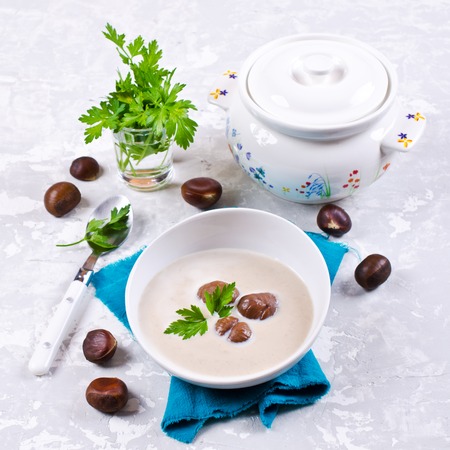 Cream soup of pureed chestnuts on a concrete background. Selective focus.の写真素材
