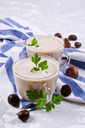 Cream soup of pureed chestnuts on a concrete background. Selective focus.の写真素材