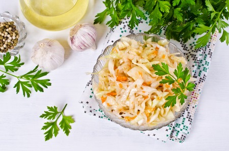 Traditional homemade sauerkraut with carrots, fennel seeds and fresh parsley. Selective focus.の写真素材
