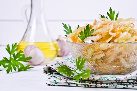 Traditional homemade sauerkraut with carrots, fennel seeds and fresh parsley. Selective focus.の写真素材
