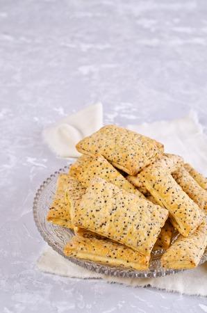 Cookies from puff pastry with poppy seeds and sugar. Selective focus.の写真素材