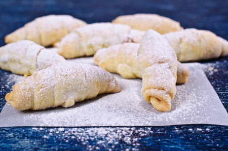 Homemade cookies twisted, sprinkled with powdered sugar,  on a dark background. Selective focus.の写真素材
