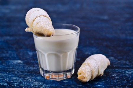Homemade cookies twisted, sprinkled with powdered sugar,  on a dark background. Selective focus.の写真素材