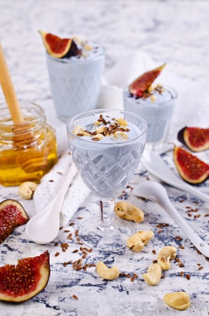 Dessert made with ricotta, figs, cashew nuts, flax seed and honey. Selective focus.の写真素材