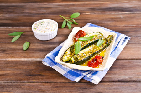 Baked zucchini with tomatoes and sage. Selective focus.の写真素材