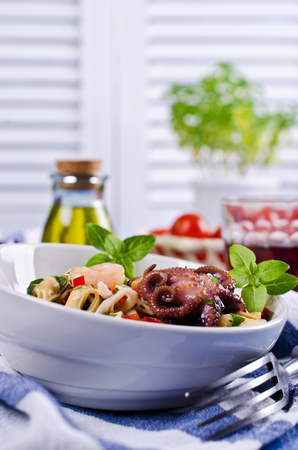 Seafood salad with vegetables and basil. Selective focus.の写真素材