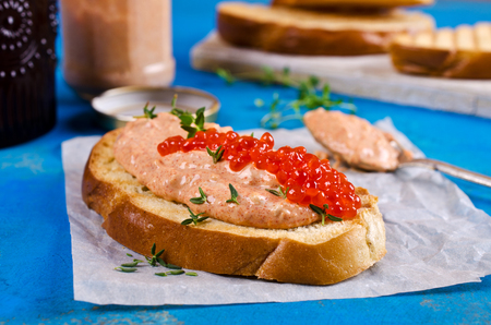 Mousse salmon and shrimp with red caviar on toast. Selective focus.の写真素材