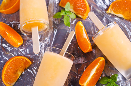 Homemade ice cream on a stick from an orange. Selective focus.の写真素材