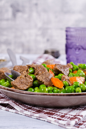 Meat stew with peas and carrots in a rustic style. Selective focus.の写真素材