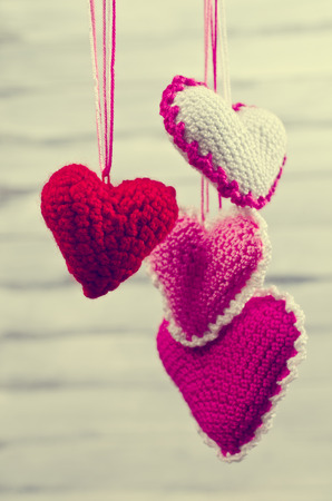 Decorative knitted heart on a wooden background. Selective focus.の写真素材