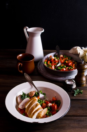 Fried chicken breast with vegetables on a dark background. Selective focus.の写真素材