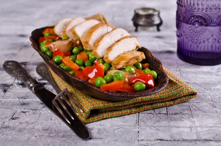 Fried chicken breast with vegetables on on light  background. Selective focus.の写真素材