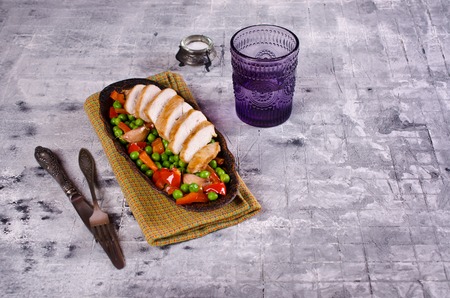 Fried chicken breast with vegetables on on light  background. Selective focus.の写真素材