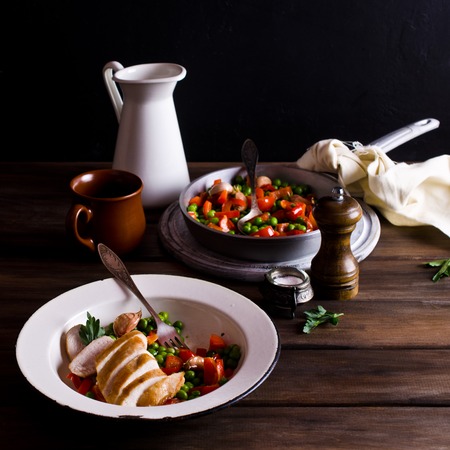 Fried chicken breast with vegetables on a dark background. Selective focus.の写真素材
