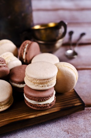 Brown and beige macaroon on a wooden background. Selective focus.の写真素材