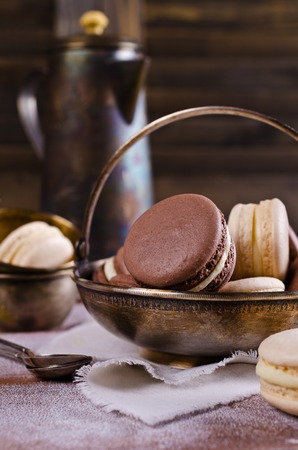 Brown and beige macaroon on a wooden background. Selective focus.の写真素材
