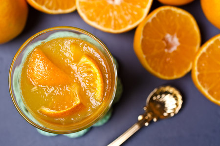 Orange jelly in glass with fruit pieces. Selective focus.の写真素材