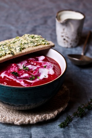 The thick beet soup with cream and toast with butter. Selective focus.の写真素材