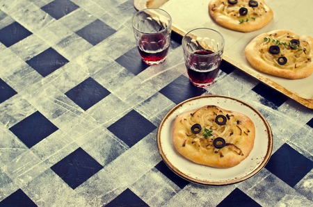 Open pie with onions and black olives. Selective focus.の写真素材