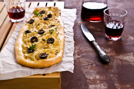 Open pie with onions and black olives. Selective focus.の写真素材