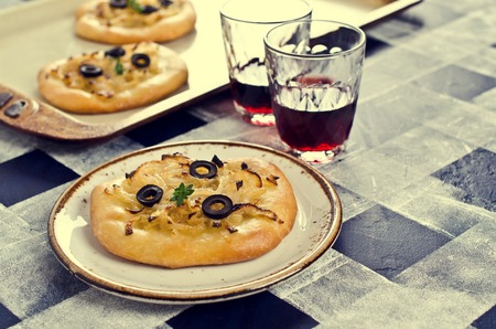 Open pie with onions and black olives. Selective focus.の写真素材