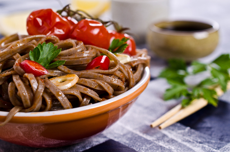 Buckwheat noodles with vegetables in a spicy sauce. Selective focus.の写真素材
