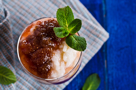 Milk rice porridge with strawberry jam. Selective focus.の写真素材