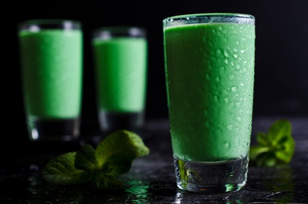 Green creamy liquid in a glass. Selective focus.の写真素材