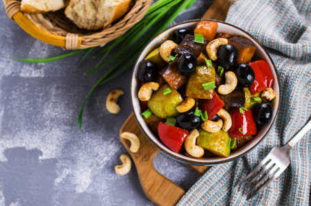 Steamed vegetables with olives and nuts. Selective focus.の写真素材