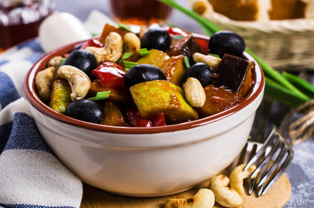 Steamed vegetables with olives and nuts. Selective focus.の写真素材