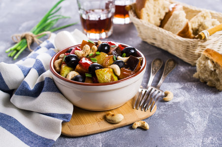 Steamed vegetables with olives and nuts. Selective focus.の写真素材