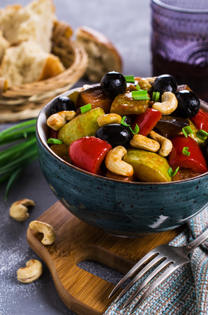 Steamed vegetables with olives and nuts. Selective focus.の写真素材