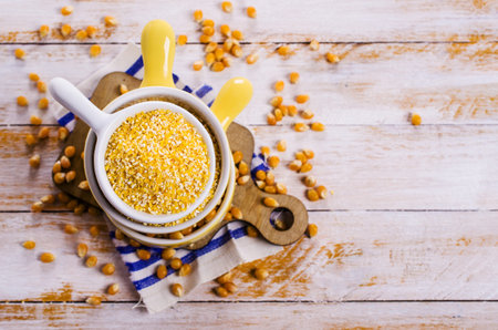 Corn grits and seeds on a wooden background. Selective focus.
