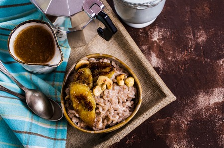 Rice porridge with banana and nuts. Selective focus.の写真素材